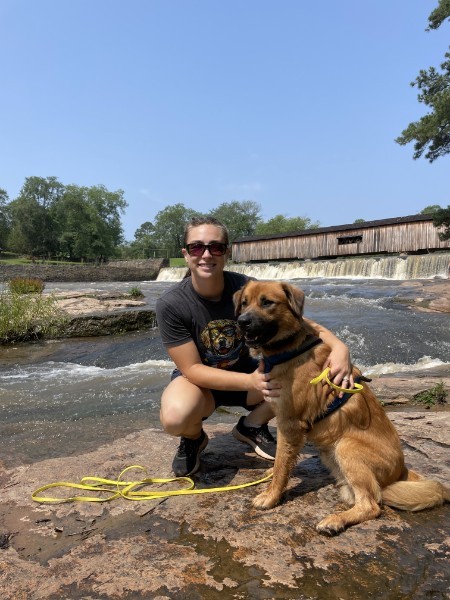 A Pleasant Paws trainer with her dog during an outdoor training outing