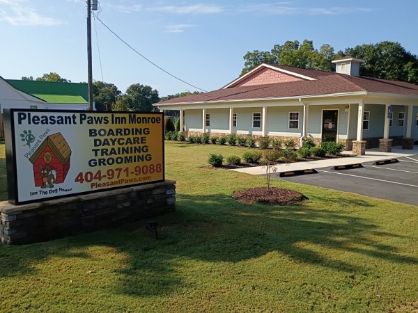 The Pleasant Paws Inn Monroe building and sign on North Broad Street in Monroe, Georgia